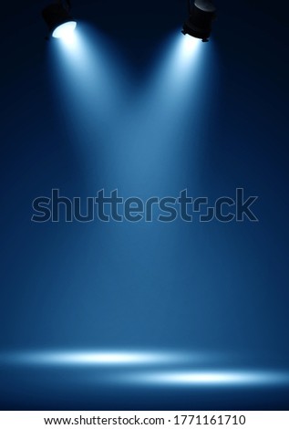 Spotlights illuminate empty stage blue background. Royalty-Free Stock Photo #1771161710