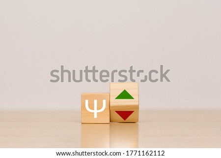 Currency sign on wooden cubes on a table and grey background. The concept of the growth and fall of the cryptocurrency exchange rate Primecoin
