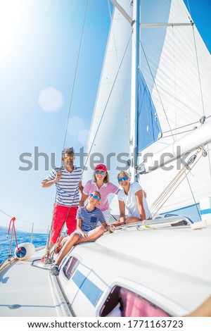 Happy family with adorable daughter and son resting on a big yacht Royalty-Free Stock Photo #1771163723