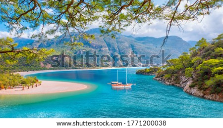 Brown gulet anchored at the Aegean sea - Panoramic view of Oludeniz Beach And Blue Lagoon, Oludeniz beach is best beaches in Turkey - Fethiye, Turkey Royalty-Free Stock Photo #1771200038