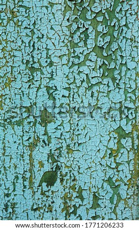The texture of cracked painted surface. Vintage old green wall