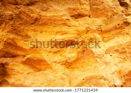 Sandstone wall background. Nature yellow sand textured background 