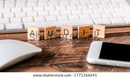 Letters on wooden pieces concept, business background, english word : audit