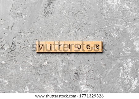 virtues word written on wood block. virtues text on cement table for your desing, concept.