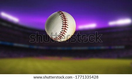 Baseball ball in the air. Close-up. The field of the stadium. Evening time