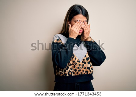 Young beautiful woman wearing casual sweatshirt standing over isolated white background rubbing eyes for fatigue and headache, sleepy and tired expression. Vision problem