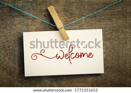 An image of a card on wire with clothes peg welcome Royalty-Free Stock Photo #1771351652