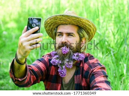 Video call. Online communication. Affordable high quality Internet and communication. Cowboy hipster in field with smartphone. Social networks. Internet available in most remote corners of country.