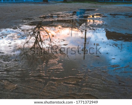 Abstract background of  reflection on water surface on the ground after rain fall ,taken at the dark evening photo contains with noise, nature beauty concept