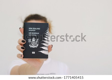 New Zealand passport in girl's hand