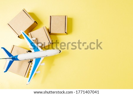 Airplane and stack of cardboard boxes. concept of air cargo and parcels, airmail. Fast delivery of goods and products. Cargo aircraft. Logistics, connection to hard-to-reach places. Banner, copy space Royalty-Free Stock Photo #1771407041