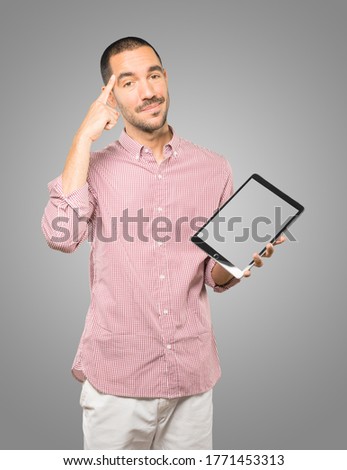 Young man doing gestures using a tablet