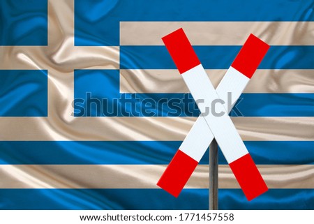 customs sign, stop, attention on the background of the silk national flag of Greece, the concept of border and customs control, violation of the state border, tourism restrictions