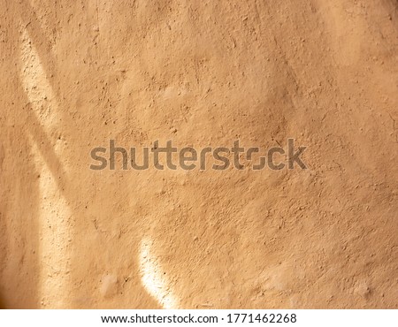 Soil wall texture of old clay house structure and sunlight. Mud home. soft picture