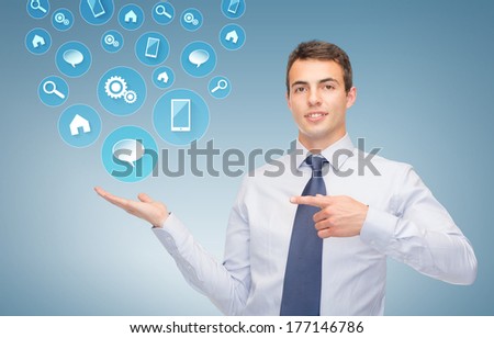 business and office, advertising, people concept - friendly young businessman showing symbols on the palm of his hand