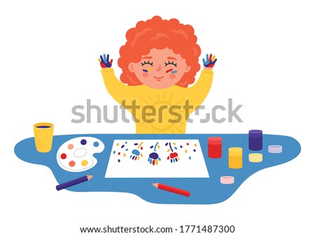 Child paints with finger paints. Little girl draws by hands. Children sensory, motor skills, creativity and imagination development playing concept. 