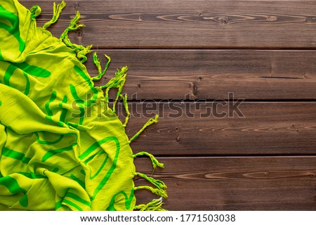 Plaid lies on a wooden background. Warm comfortable stay. Vacation concept of a country house or sauna. Flat lay with copy space and place for text.