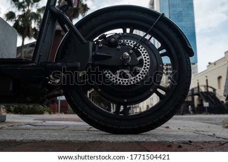Black Rubber Tire On A Motor Scooter Downtown Royalty-Free Stock Photo #1771504421