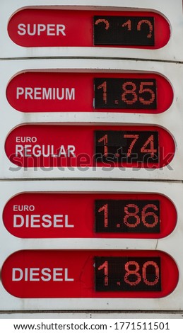 A digital, glowing shield at a gas station. The photo lists the prices of all types of fuel. The inscription in Georgian lists the types of fuel. Georgia.