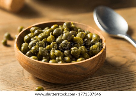 Organic Pickled Canned Capers in a Bowl Royalty-Free Stock Photo #1771537346
