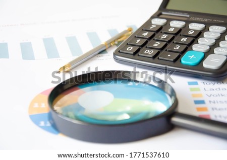 Magnifier calculator lies on a color chart. financial responsibility. High quality photo
