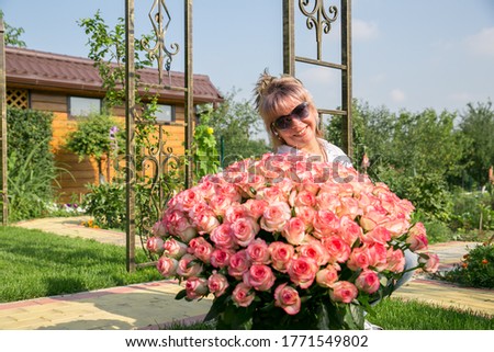 A woman with a large bouquet of rose flowers. birthday. holiday