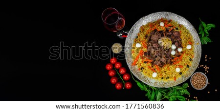 Samarkand pilaf with wegetables. on the black space background