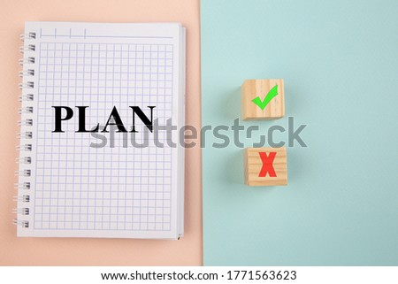 Choosing concept. Plan in notebook and Yes or No on wood blogs on colorful background