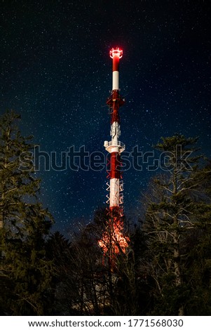 Starry night sky over the tip of the transmission tower on the top of the austrian mountain Pfaender.