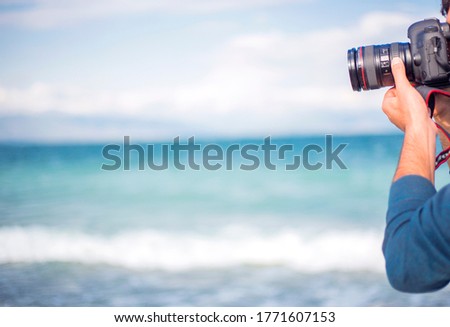Man taking photo of stunning lake 
