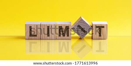 limit word written on wood block. limit text on table, yellow background, concept. Royalty-Free Stock Photo #1771613996