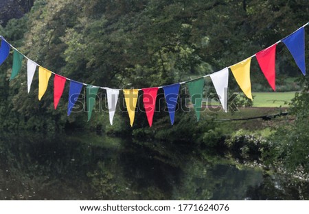 colorful decoration with triangles in a line above a river