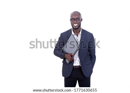 a young businessman in jacket standing on white background holding laptop and looking at the camera smiling.