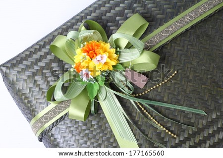 Green bow on green gift box background