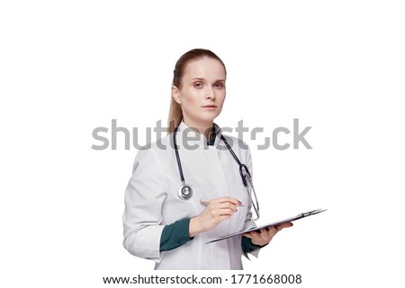 A doctor holds a clipboard and looks at the camera. Isolated background.