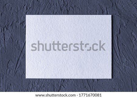white textured paper card on dark gray solid background