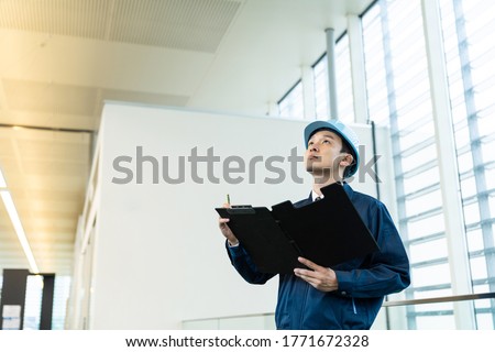 Construction worker in the building. Maintenance and inspection. Royalty-Free Stock Photo #1771672328