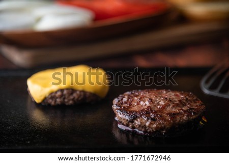 cooking burger patty on iron pan