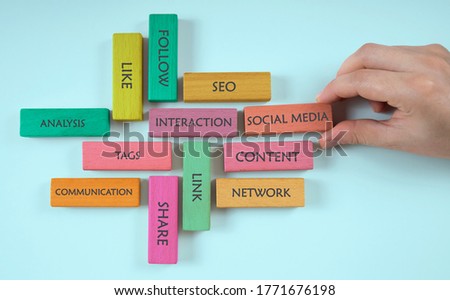 social media concept. hand chooses colorful wooden cube with social media on it