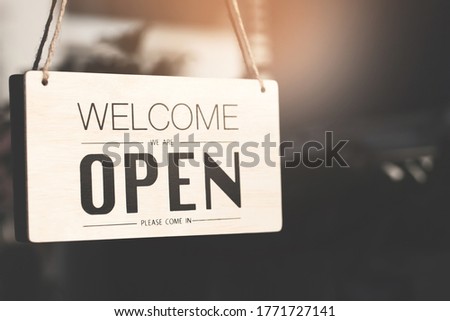 Welcome open sign on shop door. Text on cafe front or restaurant hang on door at entrance. vintage tone style. Royalty-Free Stock Photo #1771727141