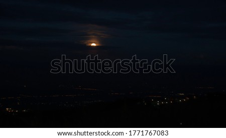 Moonlight reflecting at night on the city lights. Blur background