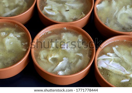 Serving Clay Bowls with Chicken Broth. A group of brown soup bowls on the table. Catering. Selective focus.
