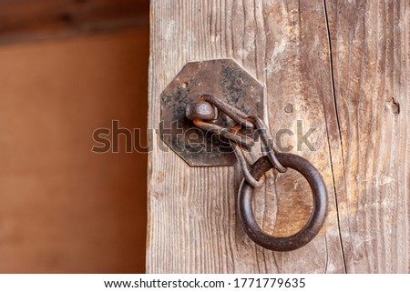 rusty chain on wooden door