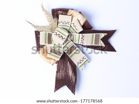 Brown bow made of ribbon isolated on white