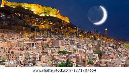 Day and night concept - The Old City Of Mardin with crescent moon - "Elements of this image furnished by NASA "