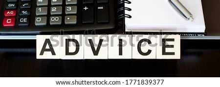 ADVICE - business concept text on wood block with laptop and calculator