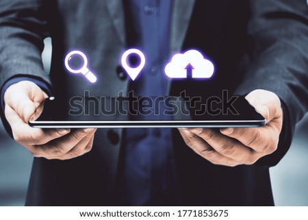 Businessman holding digital tablet with blank screen and digital icons. Technology and innovation concept.