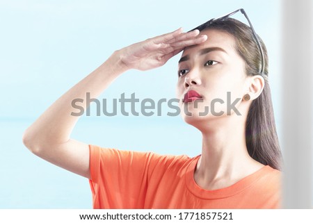 Asian woman looking at scenery view with a sky background