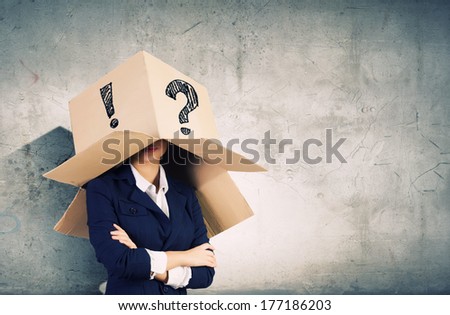 Businesswoman wearing carton box with marks on head