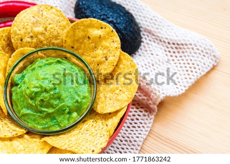 Mexican authentic homemade Guacamole with corn nachos chip traditional fresh healthy appetizer dip sauce for vegan